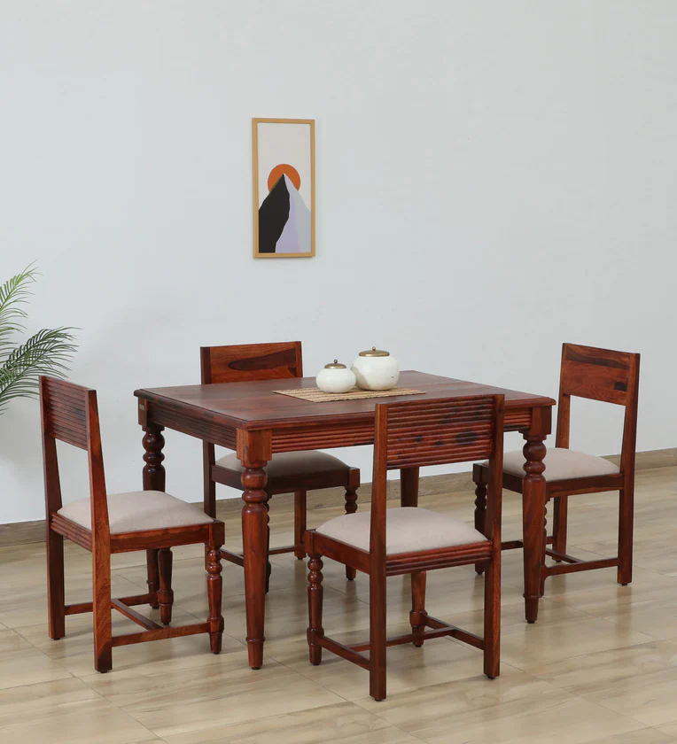 Sheesham wood kitchen dining table with rustic finish and four cushioned chairs.