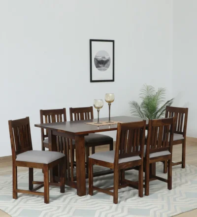 Wooden dining table with bench seating and soft chairs, ideal for modern dining rooms.