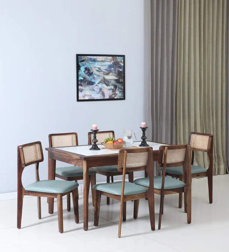 Modern dining furniture with solid wood frame, elegant legs, and cushioned chairs