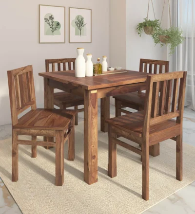 Rectangular teak dining table set featuring four armless wooden chairs