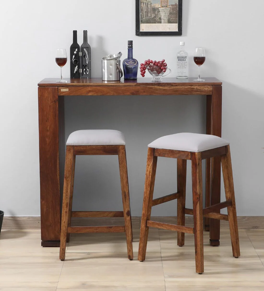 Elegant wooden bar table with 2 grey padded stools for stylish counter seating by Classic Wood.